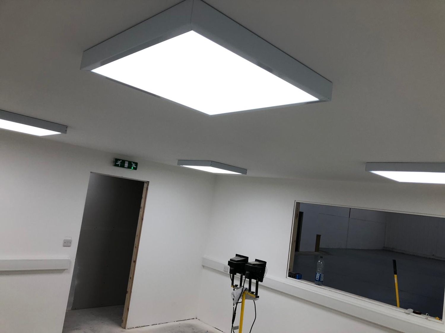 Cable containment above a commercial ceiling grid