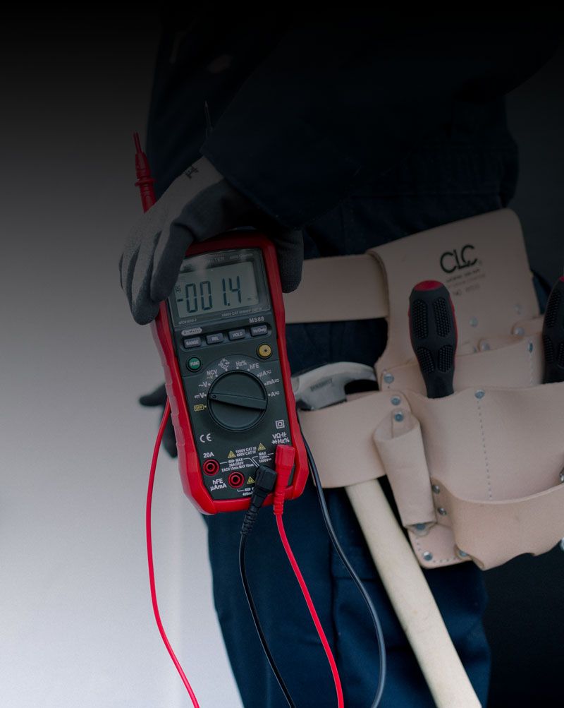 Electrician carrying out electrical inspection and testing
